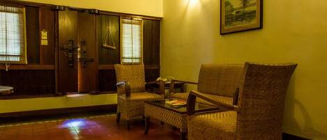 A room with a traditional wooden door, a sofa, and a coffee table.