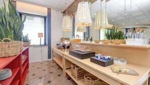 Un'impostazione buffet con diversi cibi, cesti in vimini e lampade a sospensione.
