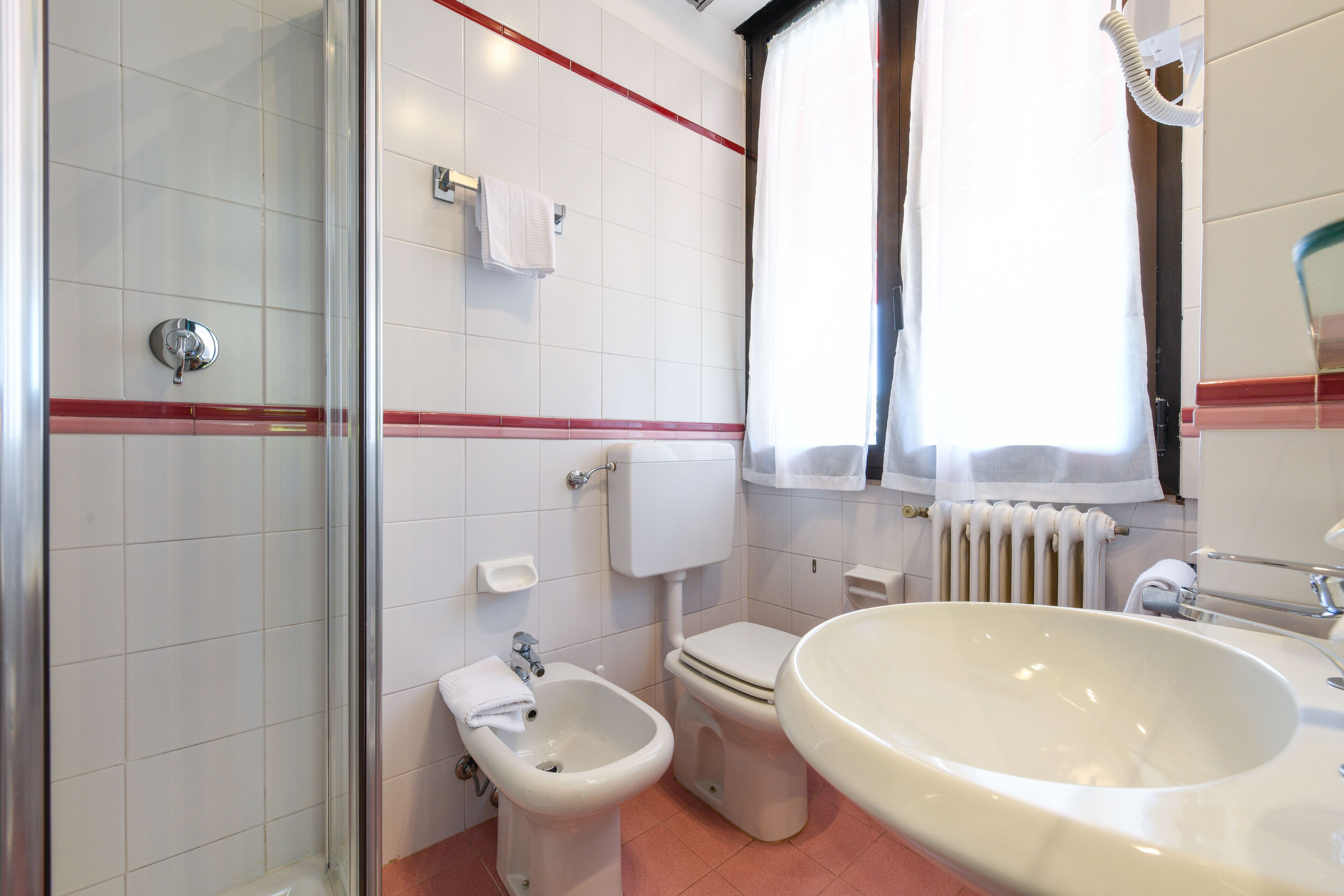economy room | bathroom | shower, free toiletries, hair dryer, bathrobes
