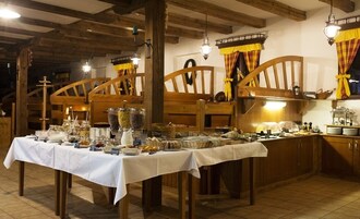 A buffet setup with various food items and a rustic wooden interior.