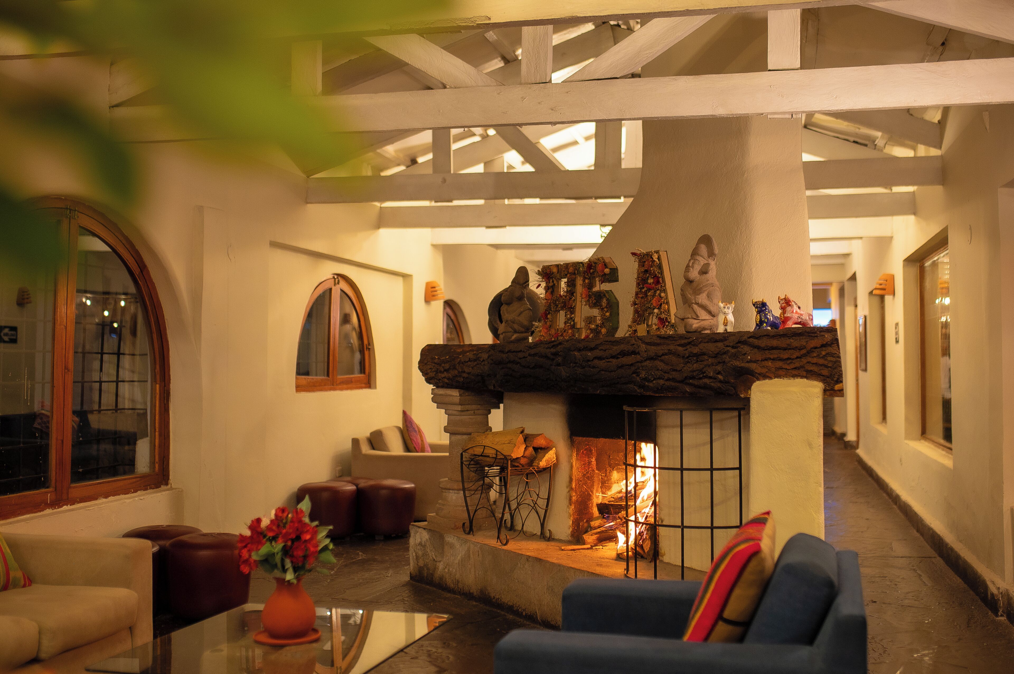 A cozy interior with a fireplace, seating area, and a stone fireplace surround.