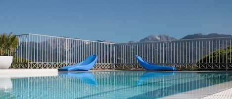 Outdoor pool, open 8:00 AM to 8:00 PM, pool loungers