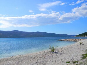 A coastal landscape with a clear sky, calm sea, and distant mountains. - Villa Rustica Dalmatia Apartments (Seget)