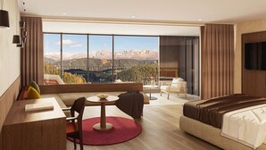 A hotel room with a large window offering a mountain view, a bed, a desk with a chair, and a small round table with a rug. - Ganis Resort (Nova Ponente)