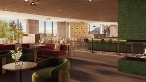 A spacious indoor area with seating arrangements, a bar, and a fireplace. - Ganis Resort (Nova Ponente)