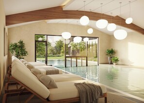 Una piscina techada, sillones reclinables de piscina