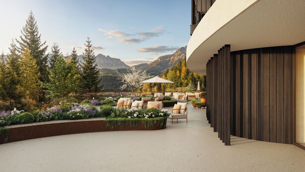 A patio with outdoor seating, a garden with various plants, and a view of mountains. - Ganis Resort (Nova Ponente)