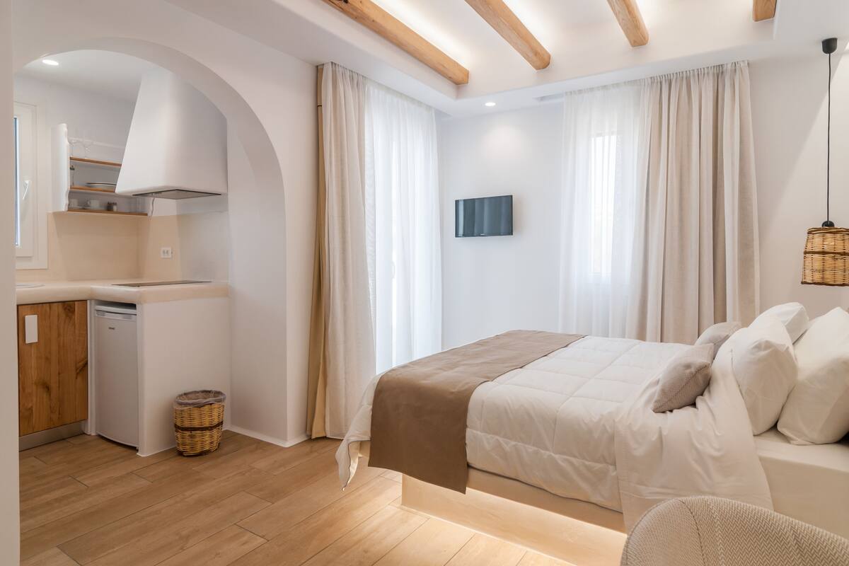 A modern bedroom with a bed, bedside table, and a built-in wardrobe.