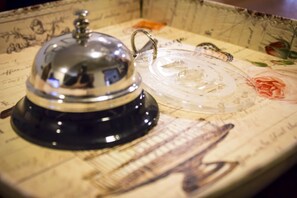 A vintage-style telephone with a clear glass cover and a metal dome. - Hotel Playa Poniente (Gijon)