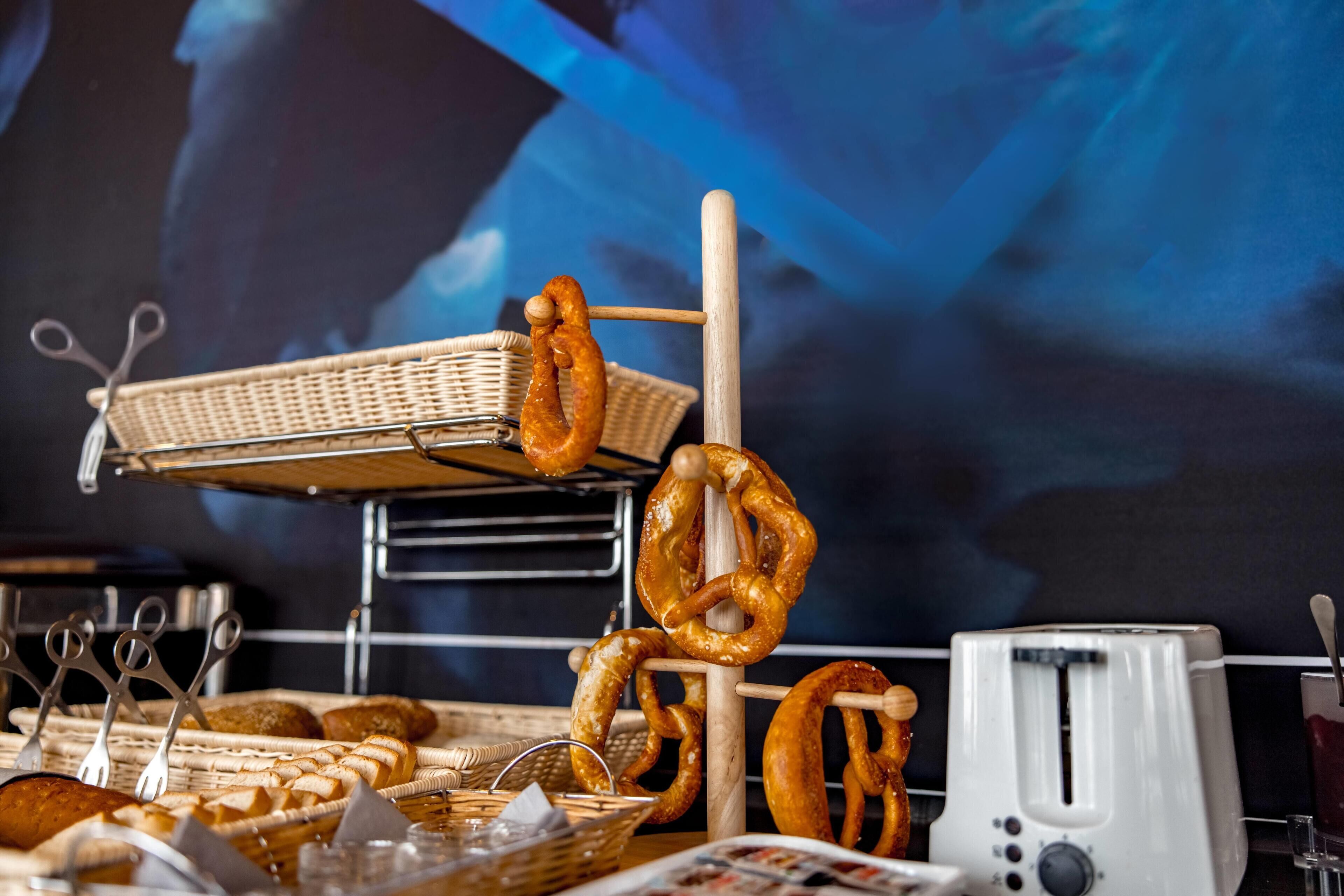 A buffet table with various food items, including pretzels and baskets.