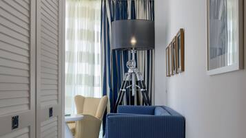 Una habitación moderna con un sofá, una lámpara trípode y una silla.