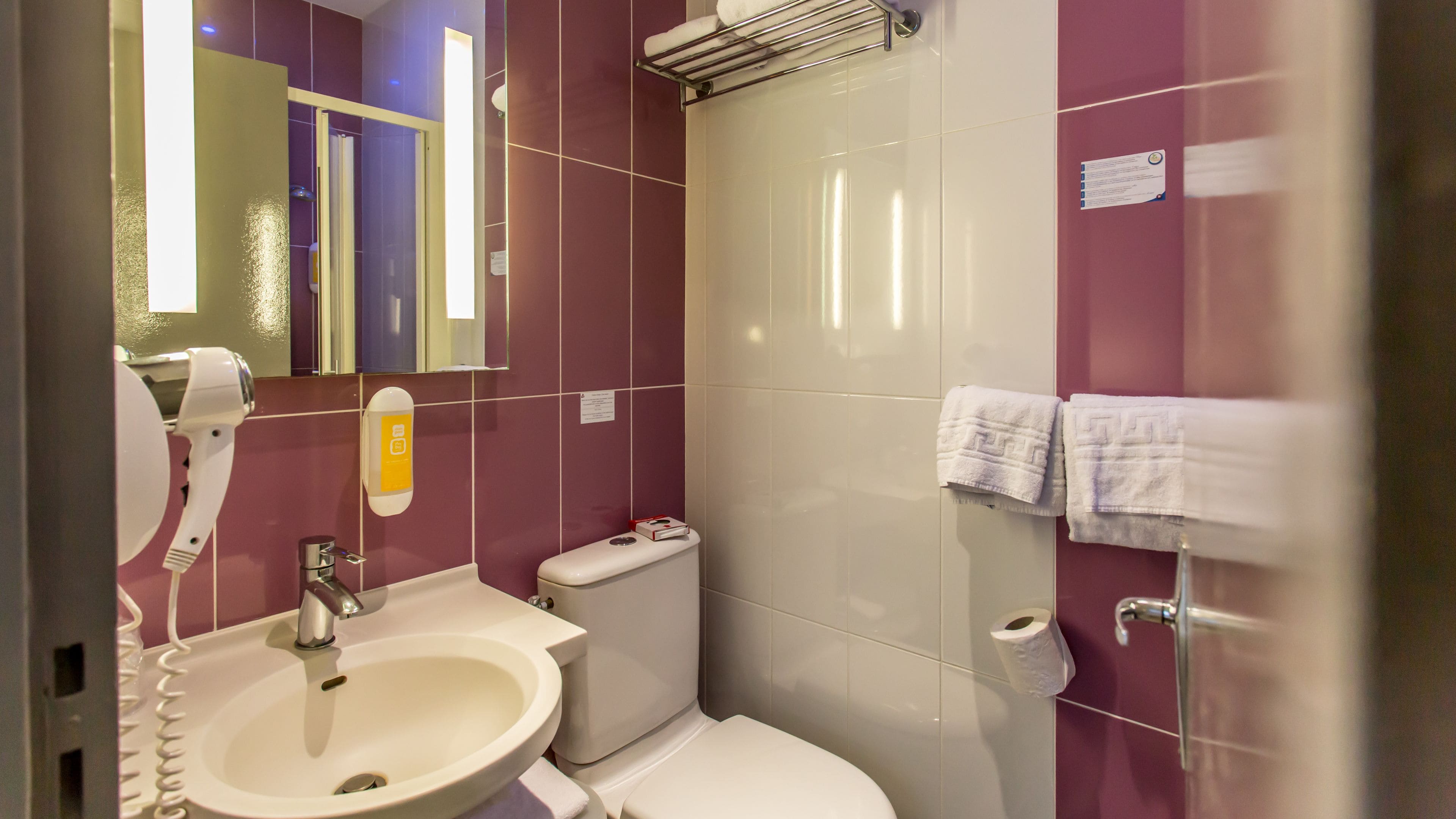 A bathroom with a sink, toilet, and shower.