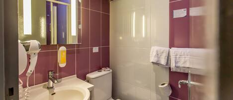 A bathroom with a sink, toilet, and shower.