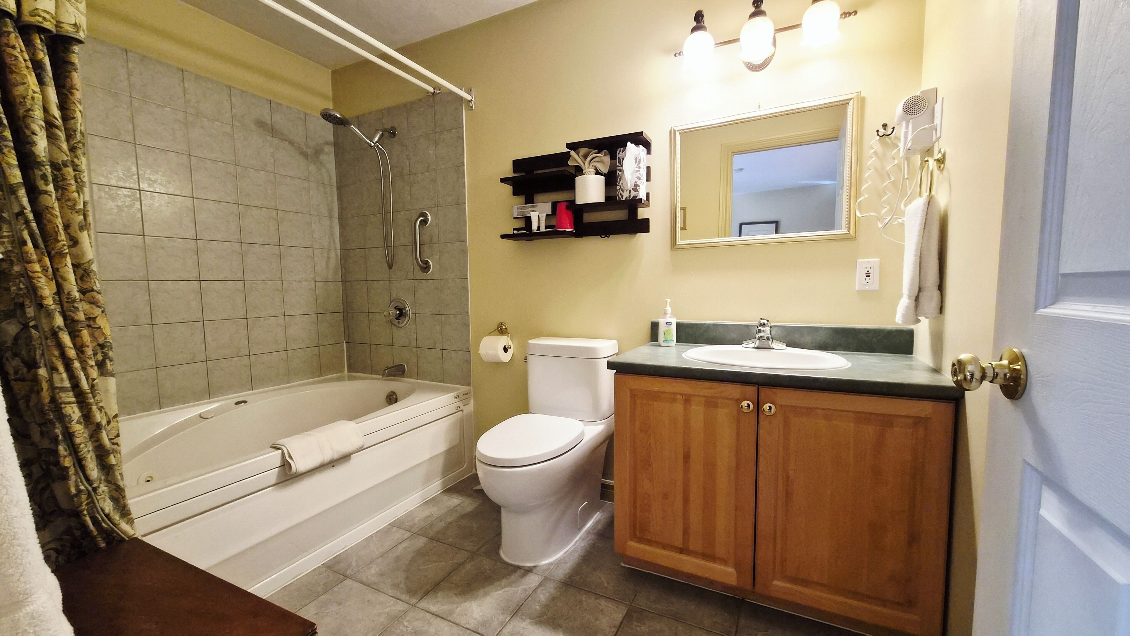 A bathroom with a bathtub, toilet, and sink.