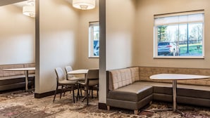 A hotel lobby with a seating area, a large window, and a patterned carpet. - Residence Inn by Marriott Duluth (Duluth)
