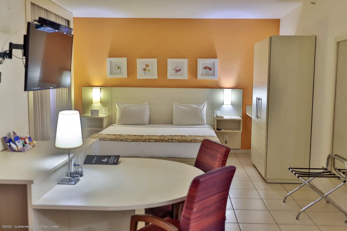 deluxe room | minibar, in-room safe, desk, laptop workspace