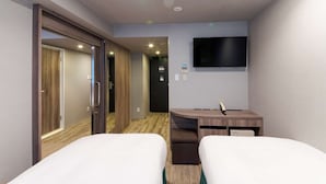 A hotel room with two beds, a desk, a flat-screen TV, and a door leading to another room. - Best Western Hotel Fino Osaka Shinsaibashi (Osaka)