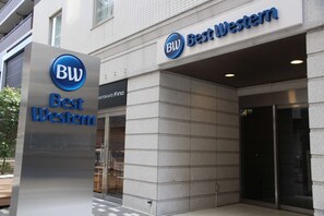A Best Western hotel entrance with a prominent sign, a glass door, and a tiled facade. - Best Western Hotel Fino Osaka Shinsaibashi (Osaka)