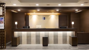 A hotel reception area with a counter, two mirrors, and two lamps. - Best Western Hotel Fino Osaka Shinsaibashi (Osaka)