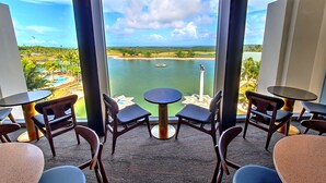 A terrace with a view of a lake, surrounded by tables and chairs. - Leopalace Resort Guam (Yona)