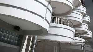 A multi-story building with a series of balconies.