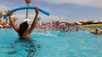 Enjoy a refreshing swim in the pool surrounded by water toys and shaded areas.