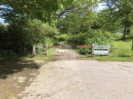 A gate with a sign welcoming visitors to the Royal Military Canal, surrounded by lush greenery.