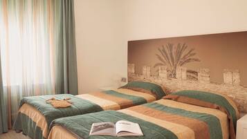 A hotel room with two beds, a large window with curtains, and a wall-mounted artwork.
