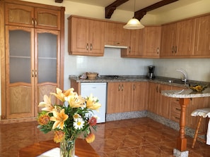 Enjoy cooking in this well-equipped kitchen with a dishwasher and sink.