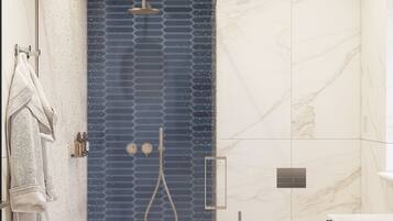 A modern bathroom with a shower, toilet, and sink.
