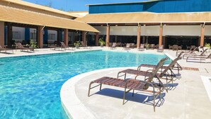 A swimming pool with lounge chairs and a covered seating area. - Nauticomar Resort All Inclusive & Beach Club (Porto Seguro)