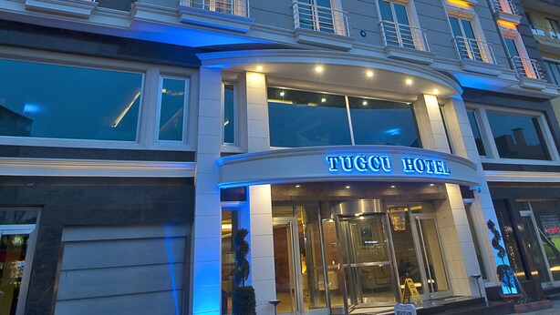 A hotel with a classic facade, large windows, and a sign reading "TUGOU HOTEL". - Tugcu Hotel Select (Bursa)