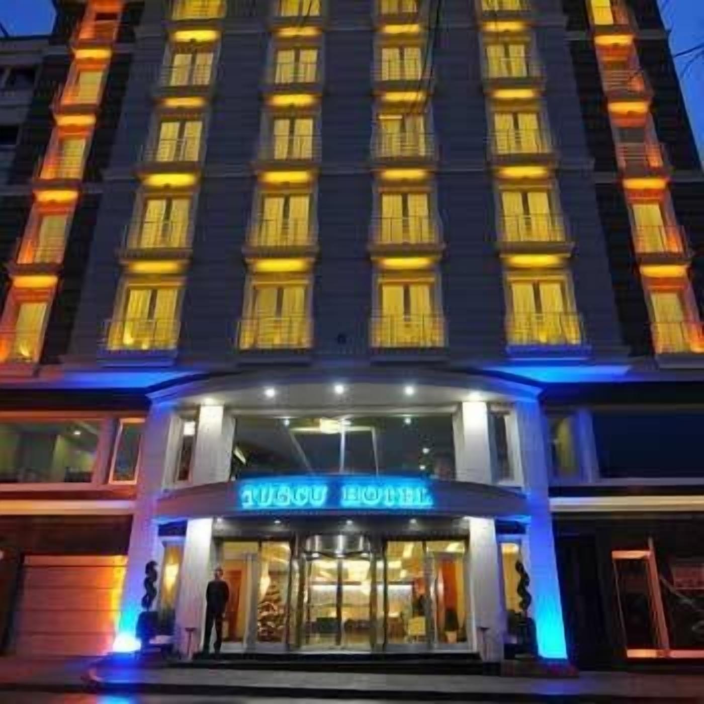 A hotel with a modern facade, multiple floors, and illuminated windows.