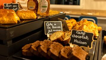 A bakery display with various baked goods and labels in French.