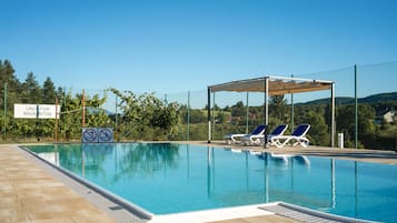 Seasonal outdoor pool, open 10 AM to 8 PM, pool umbrellas, pool loungers