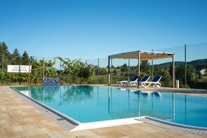 Seasonal outdoor pool, open 10 AM to 8 PM, pool umbrellas, pool loungers