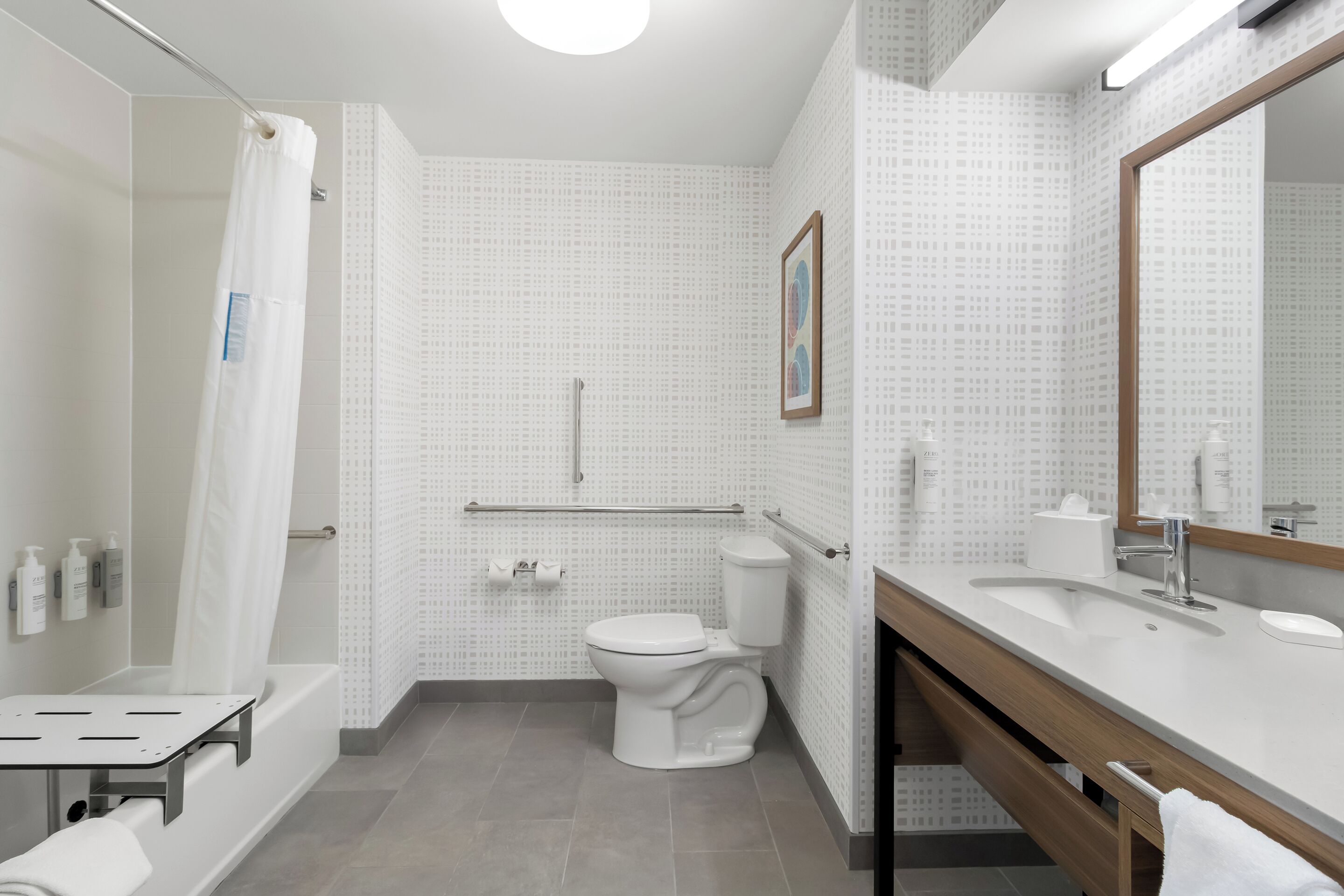 A modern bathroom with a bathtub, toilet, and sink.