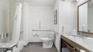 A modern bathroom with a bathtub, toilet, and sink.