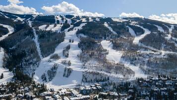 A snow-covered mountain with ski slopes and a town at the base.