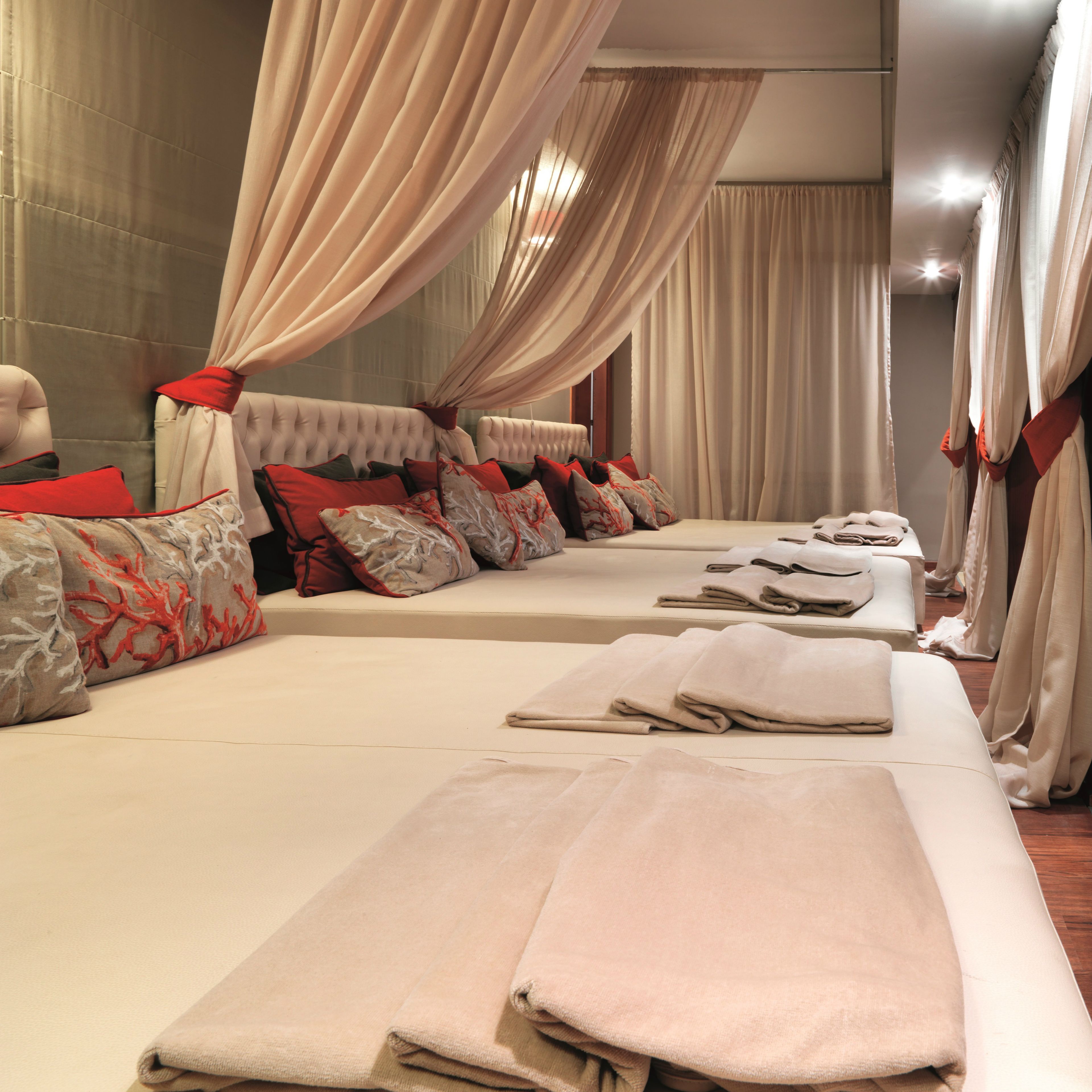 A hotel room with a large bed, multiple pillows, and a canopy bed.