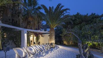 A resort entrance with a palm tree and a sign that reads "DIONYSUS."