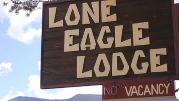 A wooden sign for Lone Eagle Lodge with a 'No Vacancy' notice.