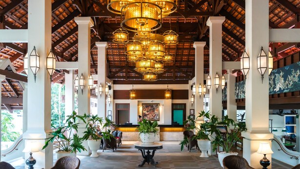 A spacious lobby with a high ceiling, ornate chandeliers, and a reception desk. - Khaolak Laguna Resort (Takua Pa)