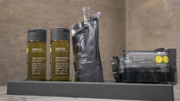 A display of Anyah Eco Spa Treatment products including hair and body wash, a cream, and a flow pack on a shelf.