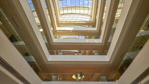 A multi-level atrium with glass railings and a central skylight. - Safir Fintas Kuwait Hotel (Fintas)