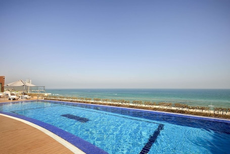Seasonal outdoor pool, open 8:00 AM to 10:00 PM, pool umbrellas