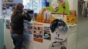 A counter with promotional materials and a person standing behind it.
