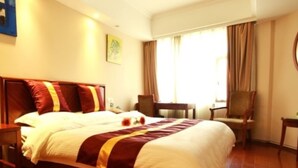 A hotel room with a large bed, a desk, two chairs, and a window with curtains. - Green Tree Inn Zhenjiang Zhongyang Street RT-MART (Zhenjiang)