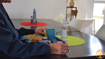 Guests can dine in comfort with a table set for one, featuring a mug, plate, and condiments.
