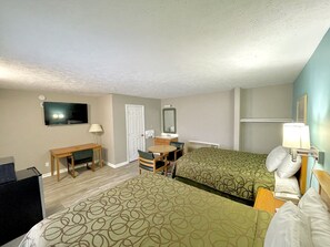 A hotel room with two beds, a desk, a chair, a TV, a mirror, and a lamp. - Overton Motel Livingston (Livingston)